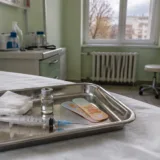 Tavă cu seringă și flacon de vaccin într-un cabinet de pediatrie